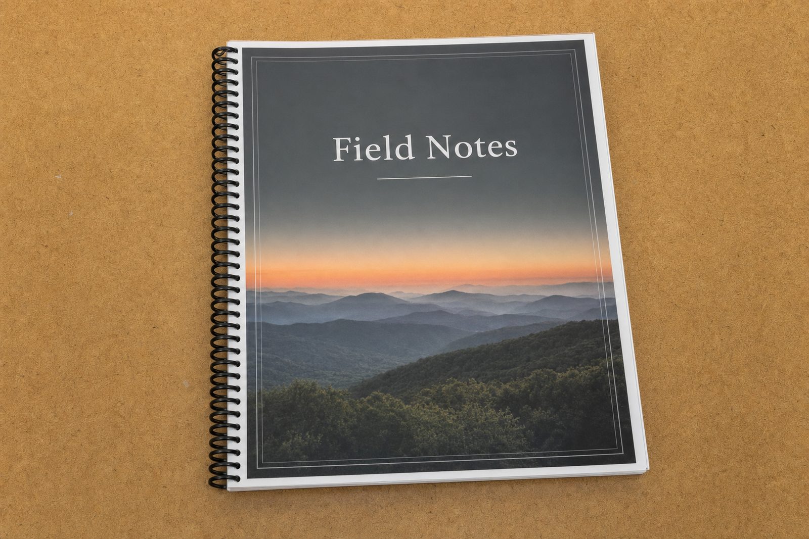 A coil-bound book with a mountain photograph on the cover