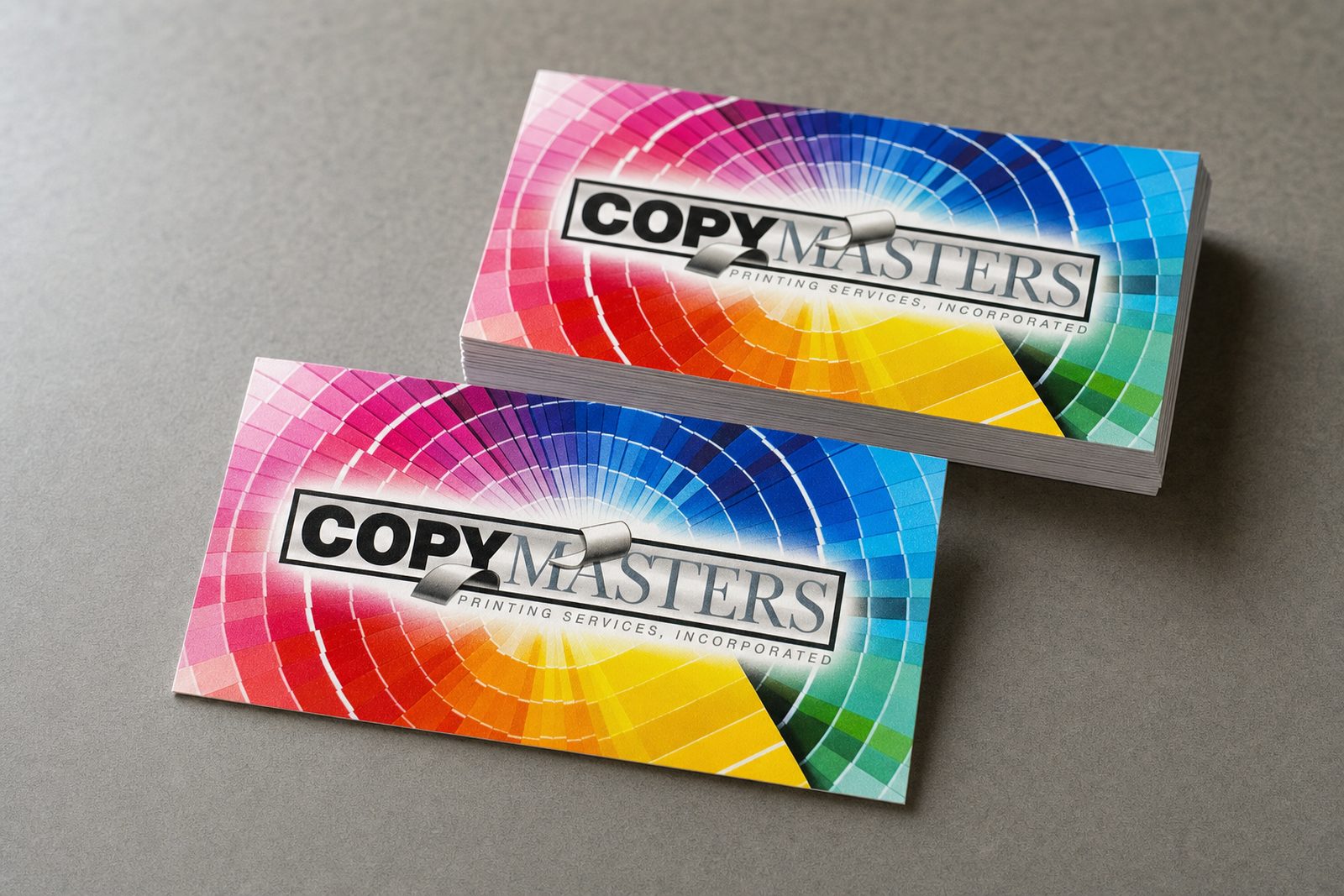 CopyMasters' own full-colour business cards on the shop's work table