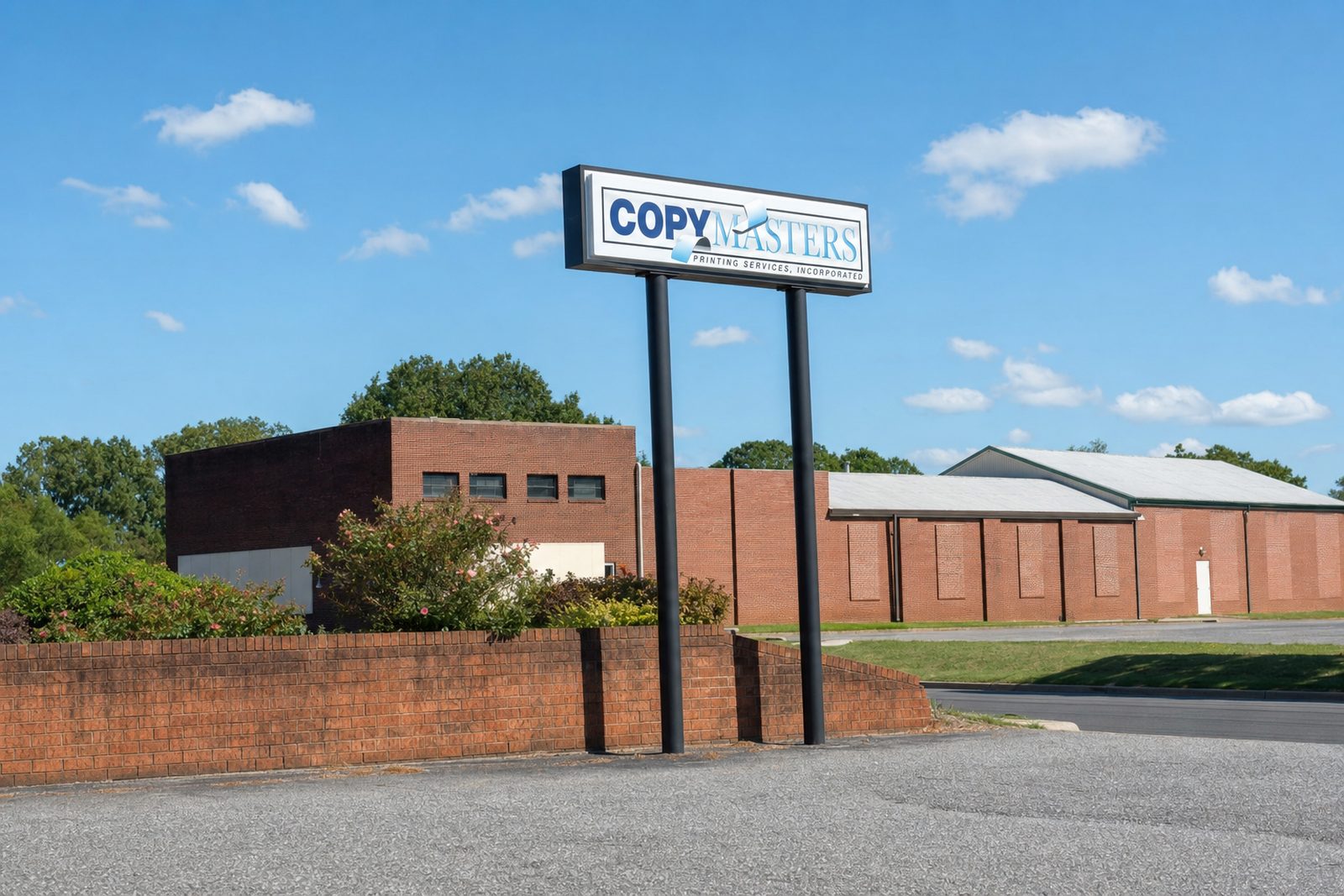 The CopyMasters pole sign on 1st Avenue SW, with the low brick buildings of the block behind it